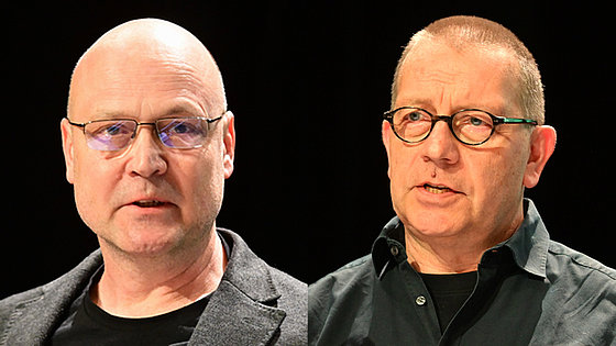 Die neuen Superintendenten der Norddeutschen Jährlichen Konferenz. Links der großgewachsene glatzköpfige Holger Sieweck im Jackett und T-Shirt. Rechts Olaf Wischhöfer im offenen schwarze Hemd und T-Shirt. Er hat sehr kurzes Haar. Beide sind Brillenträger.